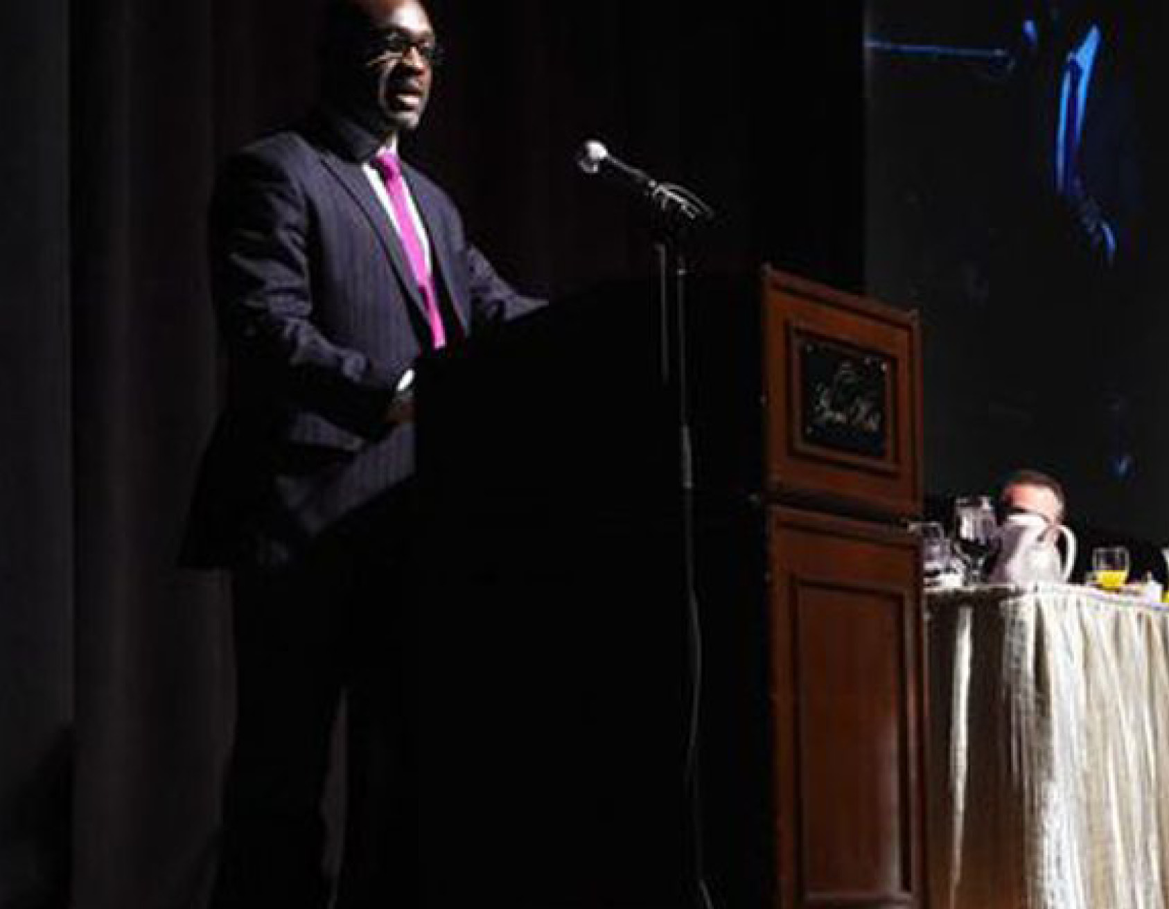 man giving a speech at podium